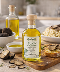 Bottle of Truffle Oil on a wooden board with truffles and pasta in the background